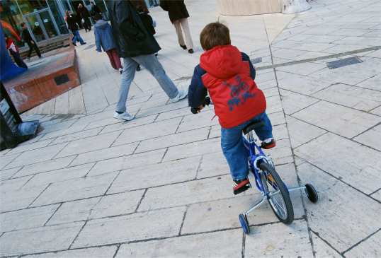 Kid Biking On Sidewalk