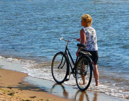 Woman Biker Near The Ocean