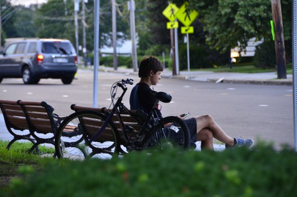 Cyclist Sitting On A Bench